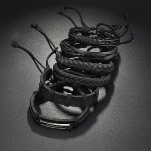 Detail view of 6-piece men's multilayer black leather bracelets with cross pendant charm