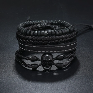 Details von mehrlagigen schwarzen Lederarmbändern mit Totenkopf und Holzperlen