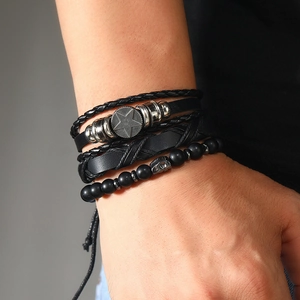 Close-up of men's multi-layer bracelet set featuring matte beads and star charms