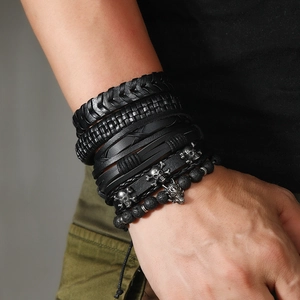 Men's punk leather wrap bracelet set with vintage silver wolf and skull charms on wrist