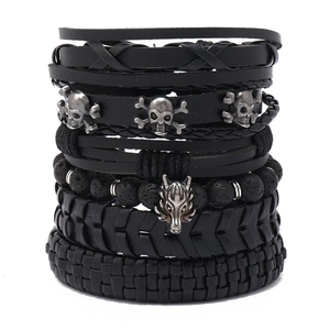 Men's punk layered bracelet set featuring leather braid, lava beads, wolf and skull charms
