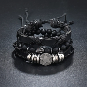 Detailed macro shot of layered leather bracelets with matte black beads and skull charms