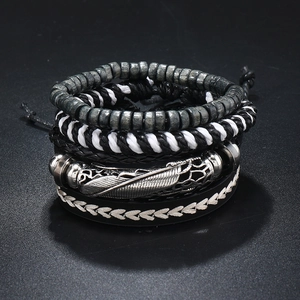 Macro shot of 4-piece men's leather bracelets with wood beads and silver feather charm
