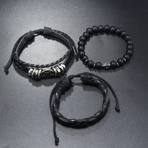 Detail view of 3pcs men's black beaded stone bracelet set with braided leather and skull