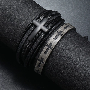 Macro detail of men's multilayer braided leather bracelets with cross metal charms