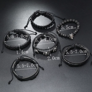 Detail view of multi-layer men's leather bracelets with wolf head and skull charms
