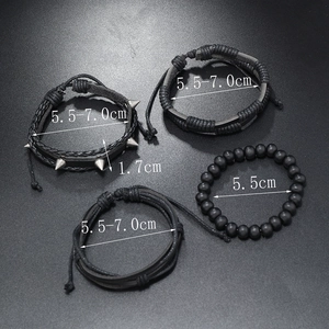 Detailed view of four-piece black punk bracelet set with metal studs and wood beads