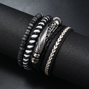 Detailed view of multilayer leather and wood bead men's bracelets with silver feather charm
