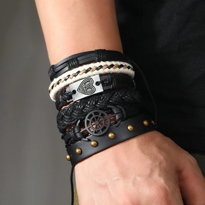 Men's 6-piece woven leather bracelet set with anchor and heart charms on a model's wrist