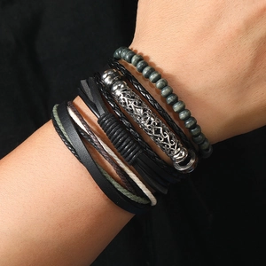 Detailed view of multilayer men's leather bracelets with wood beads and engraved metal tube