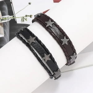 Gros plan de bracelets multicouches en cuir avec lanières tressées et clous en étoile métal