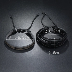 Detail view of black punk bracelets showing cross patterns and multilayer braided leather