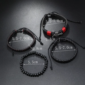 Detail view of 4-piece black braided leather bracelet set with silver cross charm and beads