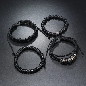 Close-up of a 4-piece men's black bracelet set with matte beads and braided leather cords