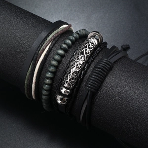 Detail of multi-layer men's leather bracelets with wooden beads and metal accents