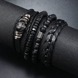 Detail view of 4-piece men's punk bracelet set with skull charm and braided leather