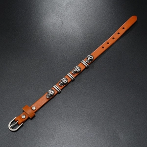 Detail of punk leather bracelet with skull studs and adjustable metal belt buckle