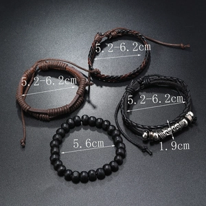 Close-up of four-piece men's leather bracelets with wooden beads and engraved metal tube