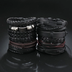 Detail of 12-piece black leather braided bracelet set with punk metal accents
