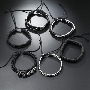 Set of six black and white layered men's bracelets with leather, rope, and beads