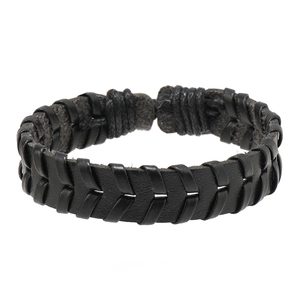 Macro detail of multi-layer black braided leather bracelet with V-shaped woven textures