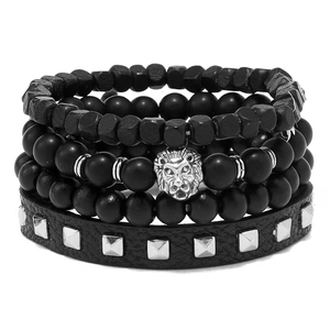 Detail of men's layered black beads and leather bracelet set with silver lion head charm