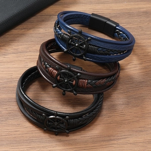 Detail view of multi-layer leather braided bracelets with nautical rudder and magnetic clasp