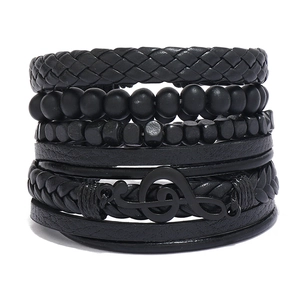 Detail of multi-layer black braided leather bracelets with music note and beads