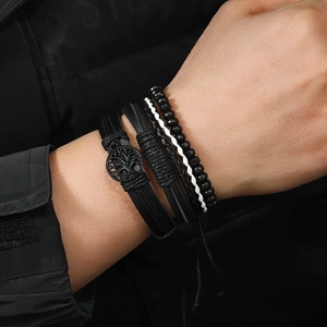 Detail view of multi-layer leather bracelets with Tree of Life pendant and black beads