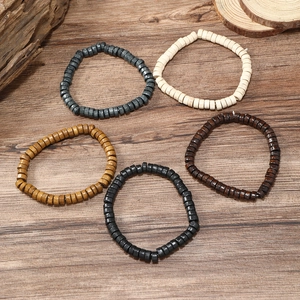 Five-piece multi-layered wooden beaded bracelet set for men on a natural wood background