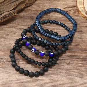 Set di 4 braccialetti da uomo con pietra lavica nera, perline in legno e amuleto occhio blu
