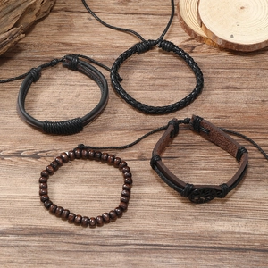 Detail of multi-layer leather bracelets with tree of life charm and wooden beads