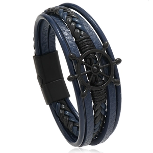 Detail of nautical multi-layer leather bracelet with black helm charm and magnetic clasp