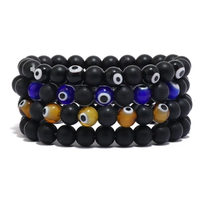Set of four matte black volcanic stone beaded bracelets with colorful evil eye charms