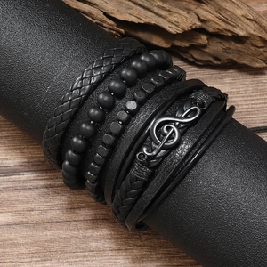 Detailed close-up of retro music note leather bracelets and black braided beads for men