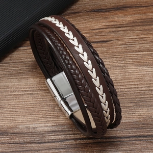 Close-up of men's multilayered brown braided leather bracelet with silver magnetic clasp