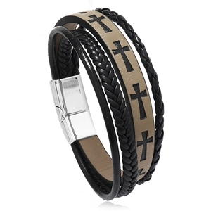 Detail of men's braided leather bracelet featuring cross patterns and magnetic buckle