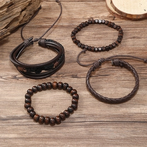 Detail of vintage 4-piece men's leather bracelet set with musical note and wood beads