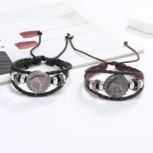 Détail de bracelets en cuir tissés main avec breloque poker vintage et perles