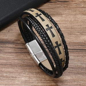 Detail of vintage braided leather bracelet with cross pattern and magnetic metal clasp