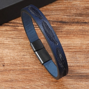 Navy blue leather bracelet with embossed feather pattern and matte black magnetic clasp