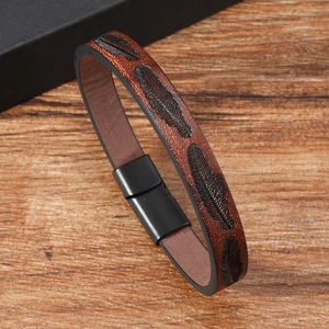 Close-up of vintage brown leather bracelet with feather texture and magnetic clasp