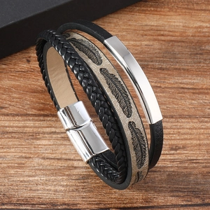 Detail of multi-layer leather bracelet featuring feather embossing and magnetic metal clasp