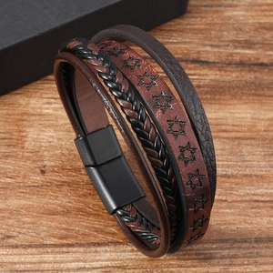 Macro shot of multi-layer braided leather bracelet with star motif and magnetic clasp
