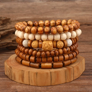 Detail of six-piece men's beaded bracelet set featuring volcanic stone and natural wood beads
