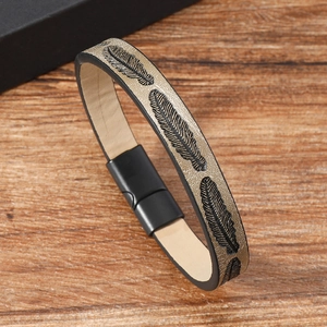 Detail of vintage brown leather bracelet featuring feather embossing and magnetic clasp