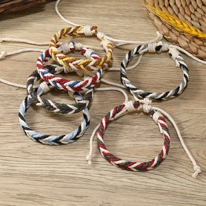 Macro detail of multicolored braided cotton rope friendship bracelets with adjustable cords