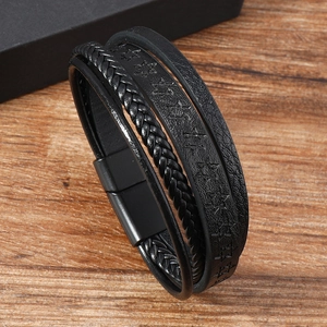 Men's retro braided leather bracelet with star relief and magnetic clasp on wood