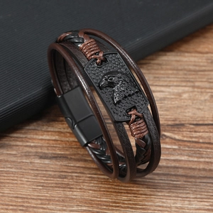 Macro shot of men's multilayer leather bracelet with eagle relief and magnetic buckle