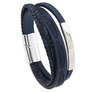 Close-up of multilayer leather bracelet with embossed feather pattern and magnetic clasp